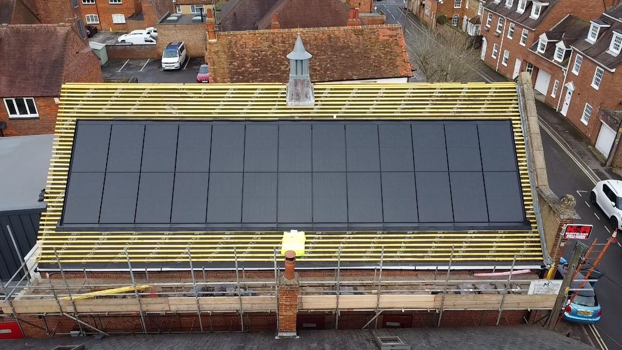 Solar panels on the roof of Thame players during installation process